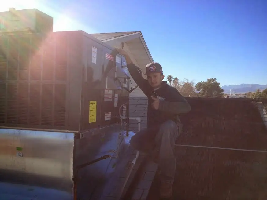 HVAC technician performing Heat Pump Repair on a rooftop unit in Vidalia